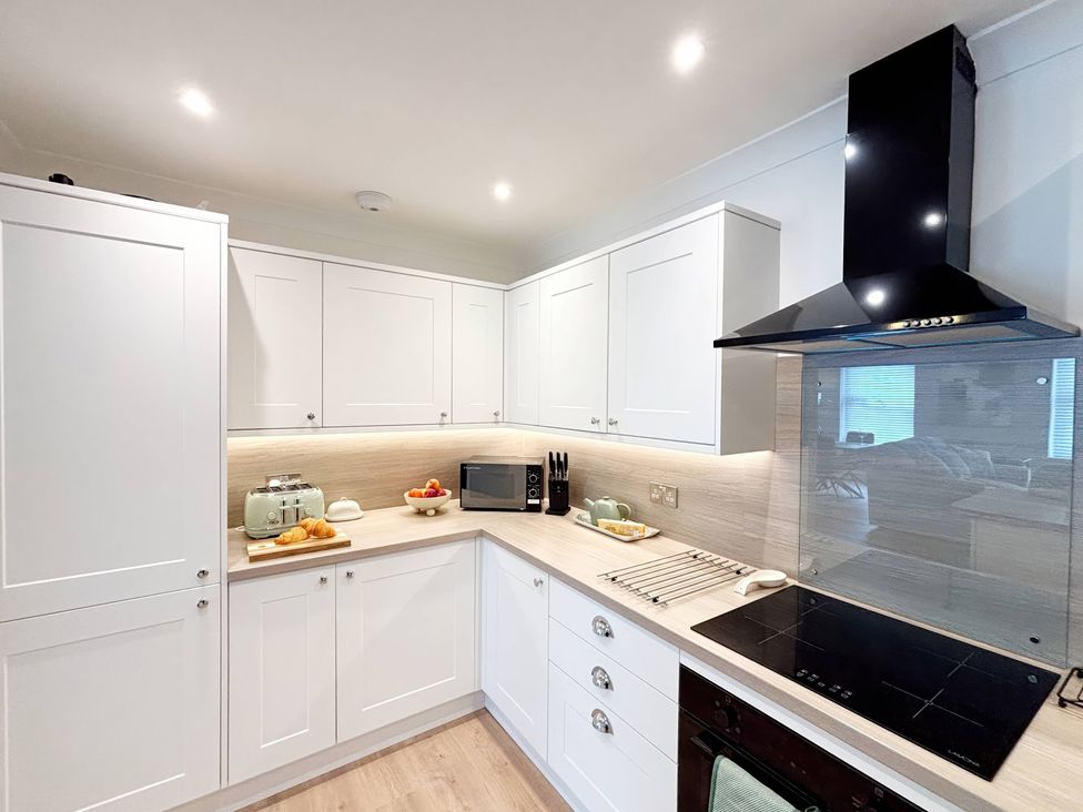 A kitchen with cabinets and appliances at The Forbes in Torquay
