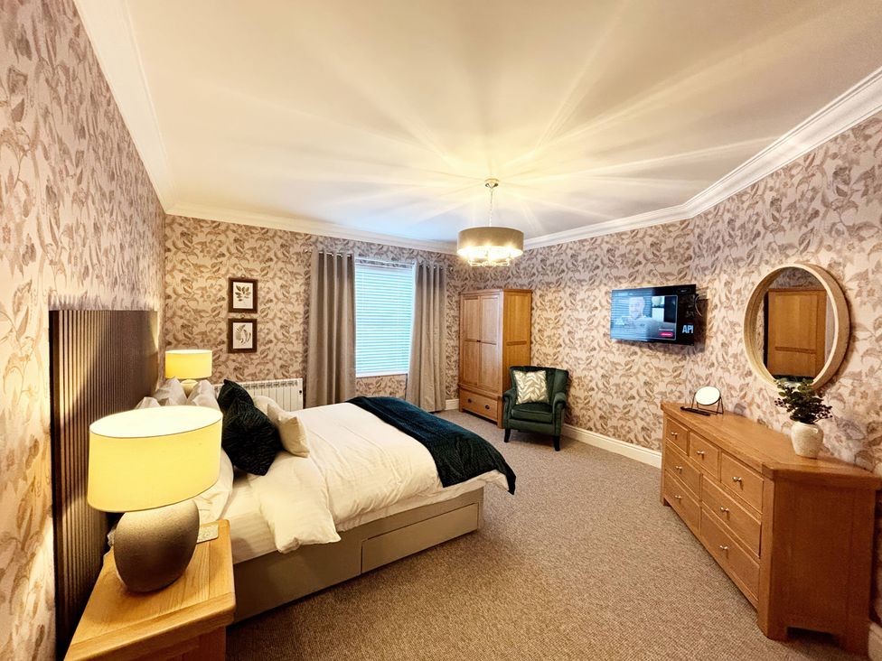 A bedroom with a bed and a dresser at The Forbes in Torquay
