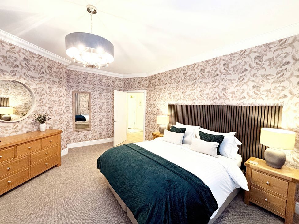 A bedroom with a bed and furniture at The Forbes in Torquay