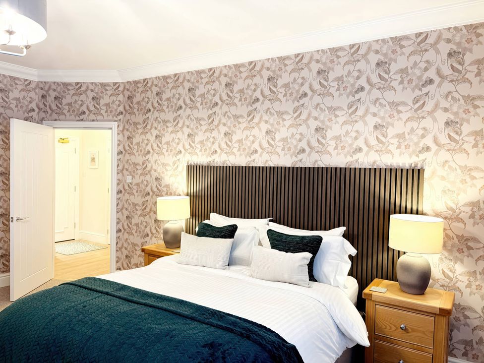 A bedroom with a bed and lamps at The Forbes in Torquay