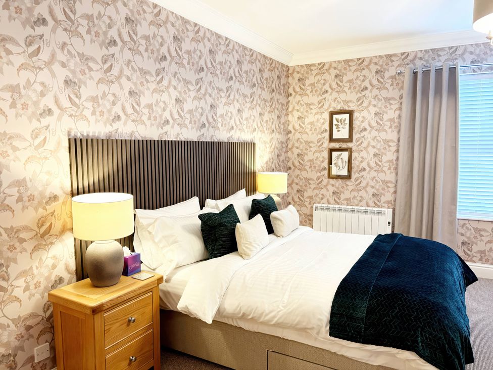 A bedroom with a bed and bedside table at The Forbes in Torquay