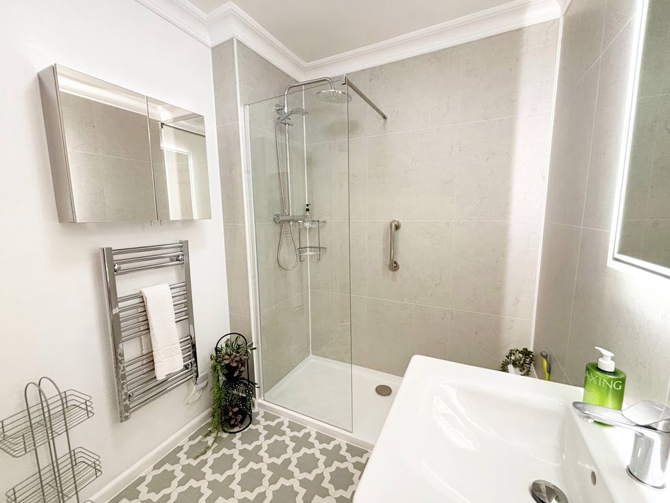 A bathroom with a shower and sink at The Forbes in Torquay