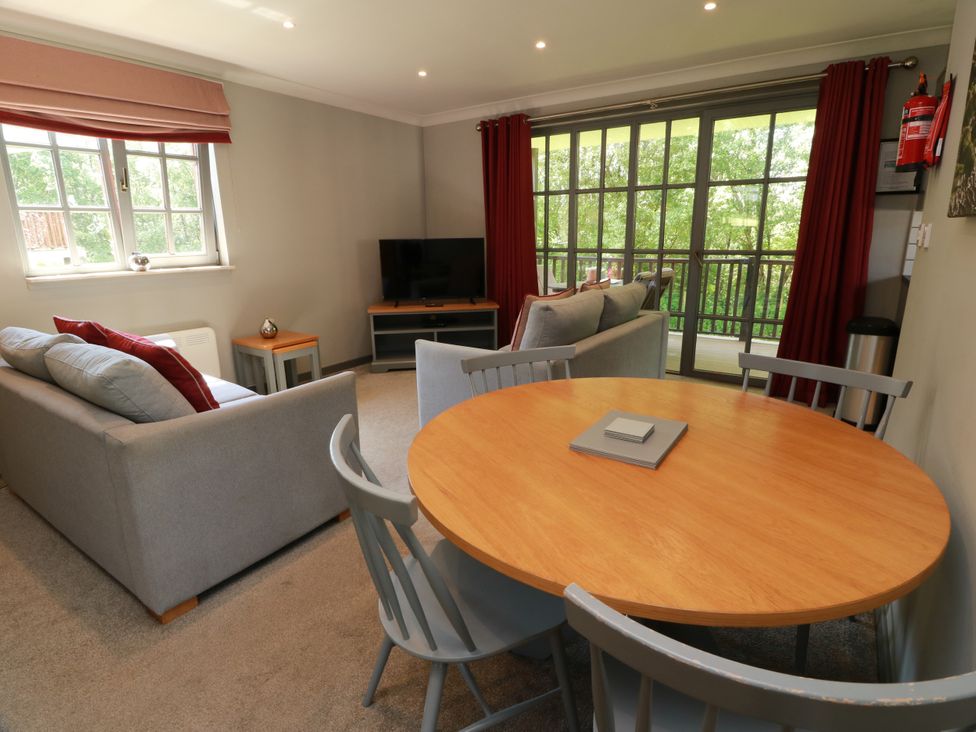 A living room with a sofa and dining table at 7 Brunston Avenue