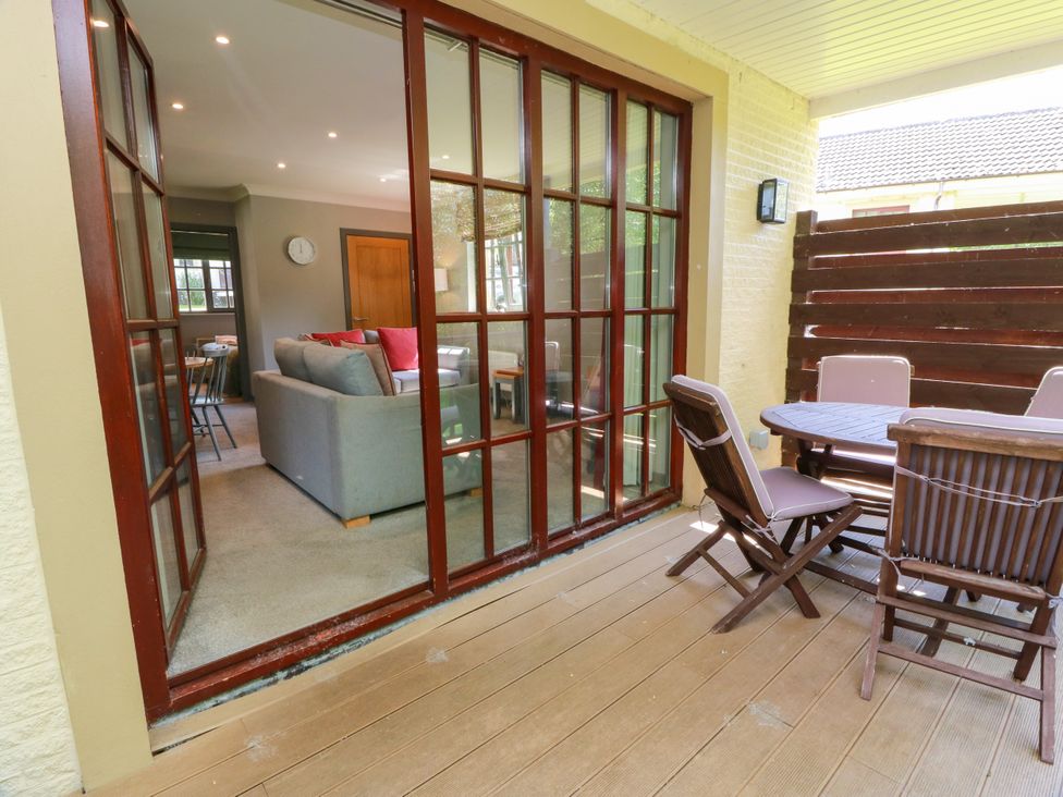 An outdoor area with glass doors and dining furniture at 7 Brunston Avenue 