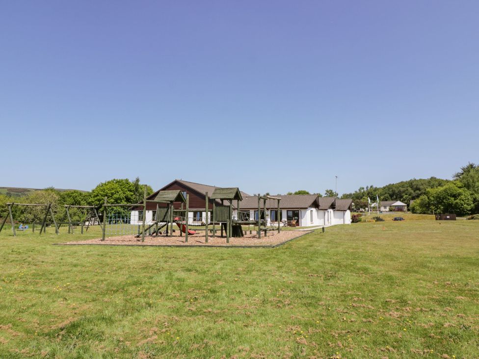 A playground with swings and a building at 7 Brunston Avenue in 