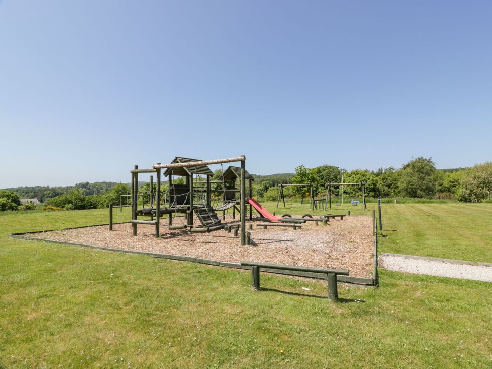 A playground with a slide and swings in a grassy area at 7 Brunston Avenue