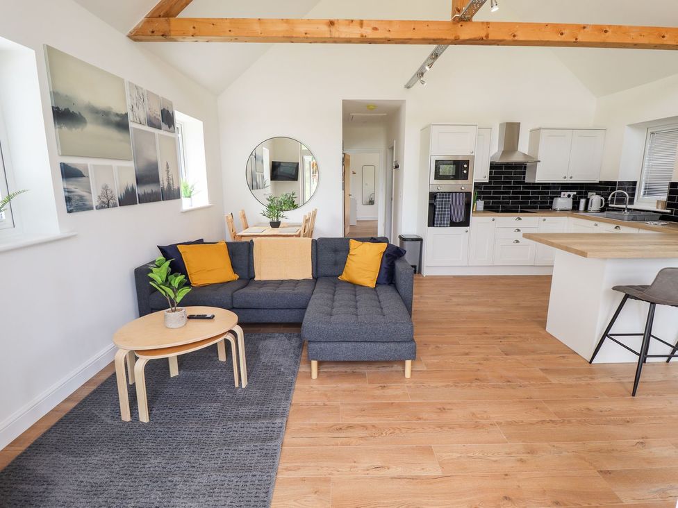 A living room with a sofa and dining area at The Lilac Owl in Lincoln