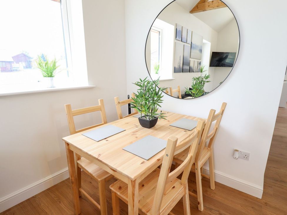 A dining room with a table and chairs at The Lilac Owl in Lincoln
