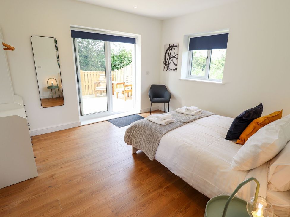 A bedroom with a bed and sliding door at The Lilac Owl in Lincoln