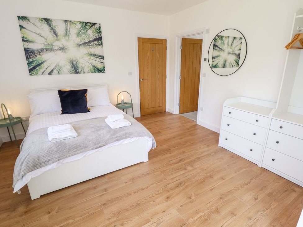 A bedroom with a bed and a dresser at The Lilac Owl in Lincoln