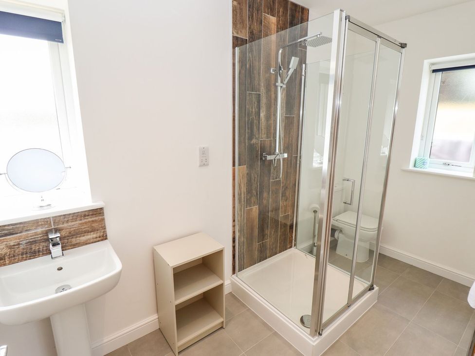 A bathroom with a shower and sink at The Lilac Owl in Lincoln