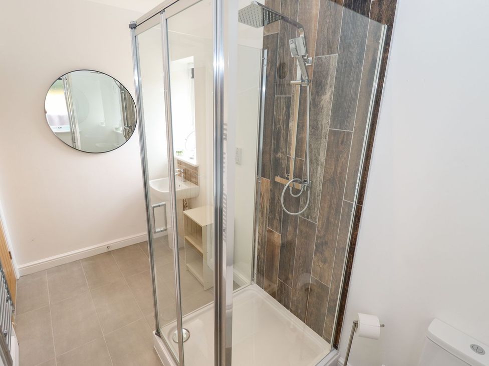 A bathroom with a shower and sink at The Lilac Owl in Lincoln