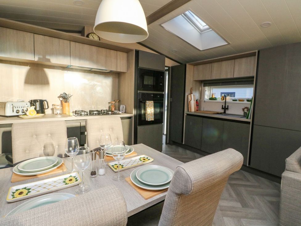 A kitchen with a dining table and appliances at Hollybirch in Crieff