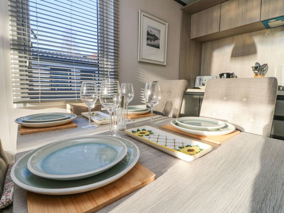 A dining room setup with plates and glasses at Hollybirch in Crieff