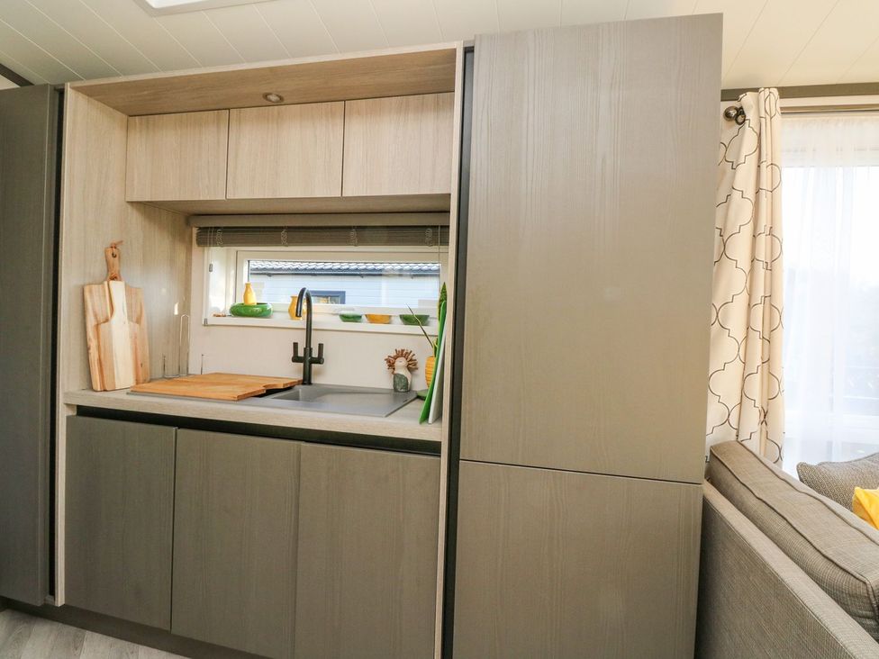 A kitchen with cabinets and a sink at Hollybirch in Crieff