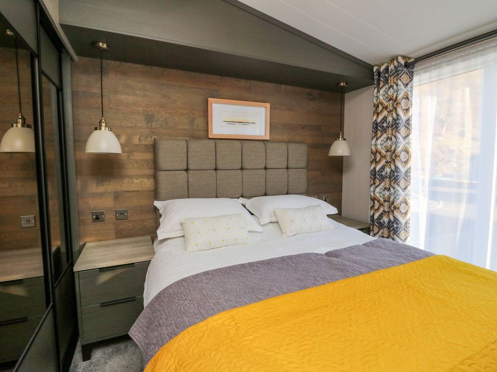 A bedroom with a bed and bedside table at Hollybirch in Crieff