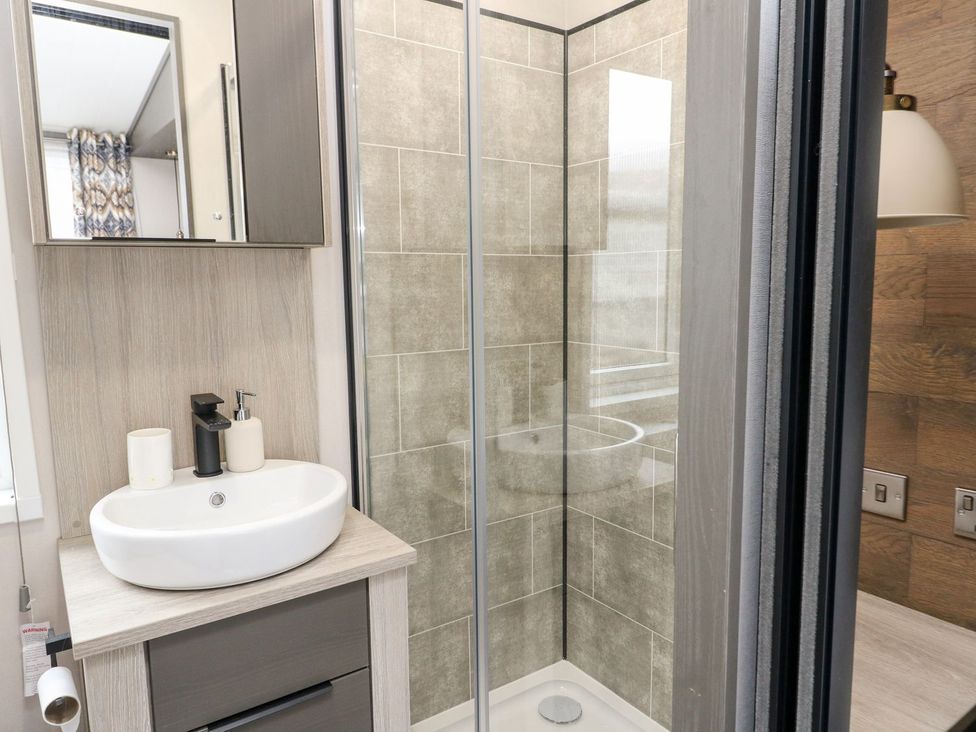 A bathroom with a wash basin and shower at Hollybirch in Crieff