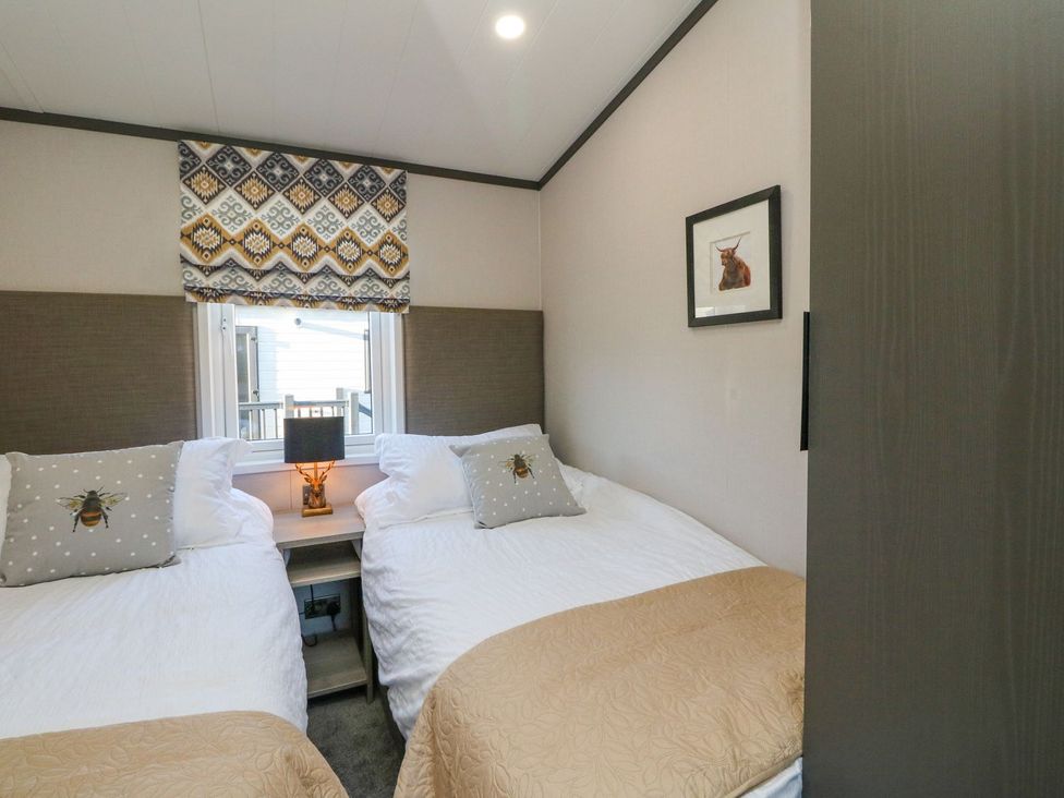 A bedroom with two beds and a window at Hollybirch in Crieff