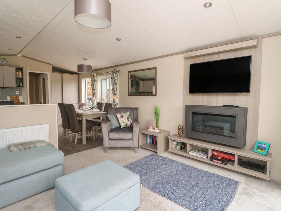 A living room with a seating area and dining space at Rowan in Crieff