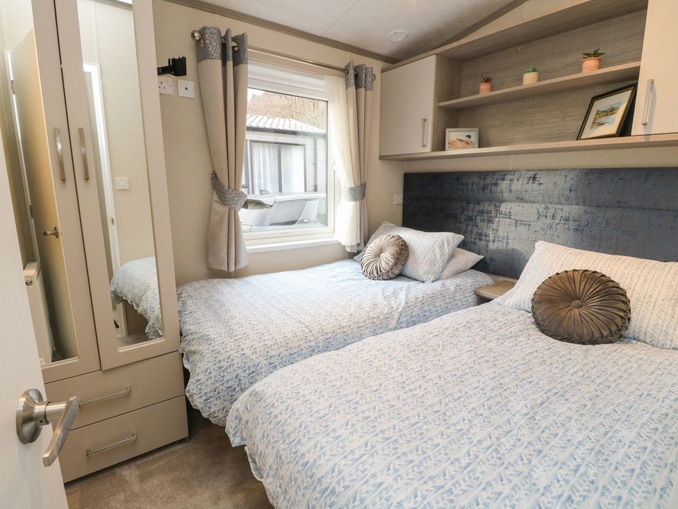A bedroom with two beds and a window at Rowan in Crieff