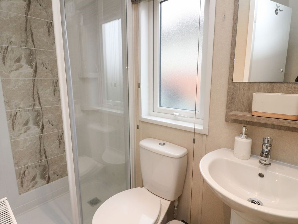 A bathroom with a shower, toilet, and sink at Rowan in Crieff