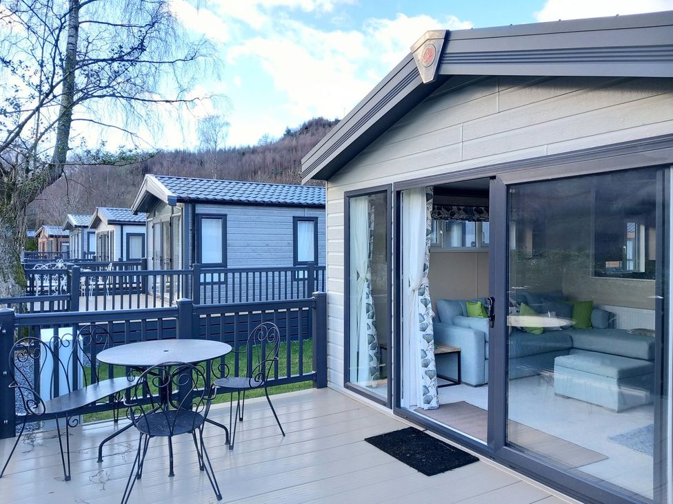 An outdoor patio with a table and chairs at Rowan in Crieff