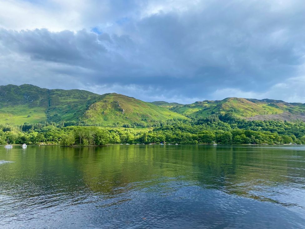 A lake surrounded by mountains and trees at Rowan in Crieff