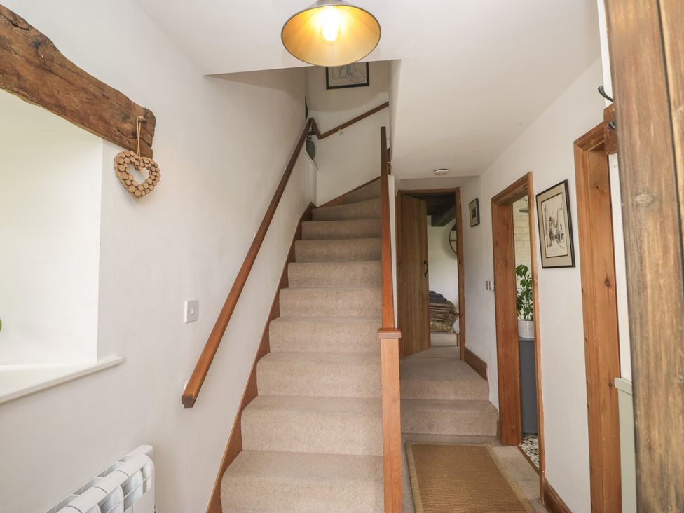 A staircase in a hallway at Over Brow Cottage in Coniston