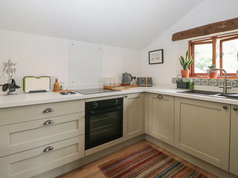 A kitchen with an oven and cooktop at Over Brow Cottage in Coniston