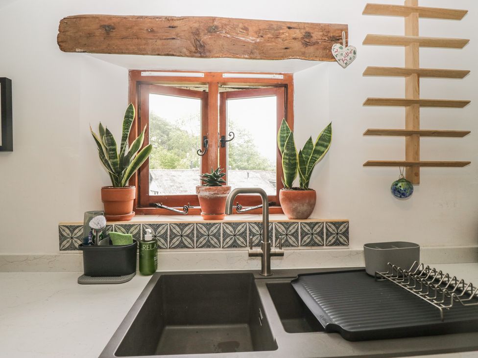 A kitchen with a sink and window at Over Brow Cottage in Coniston