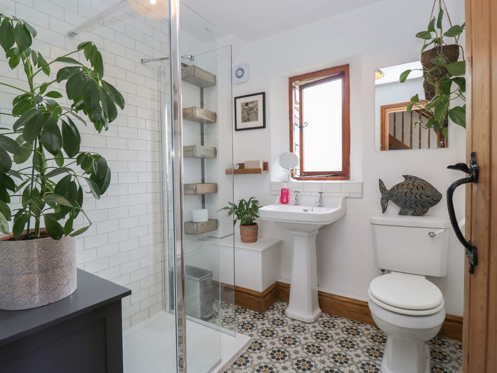 A bathroom with a shower and washbasin at Over Brow Cottage in Coniston