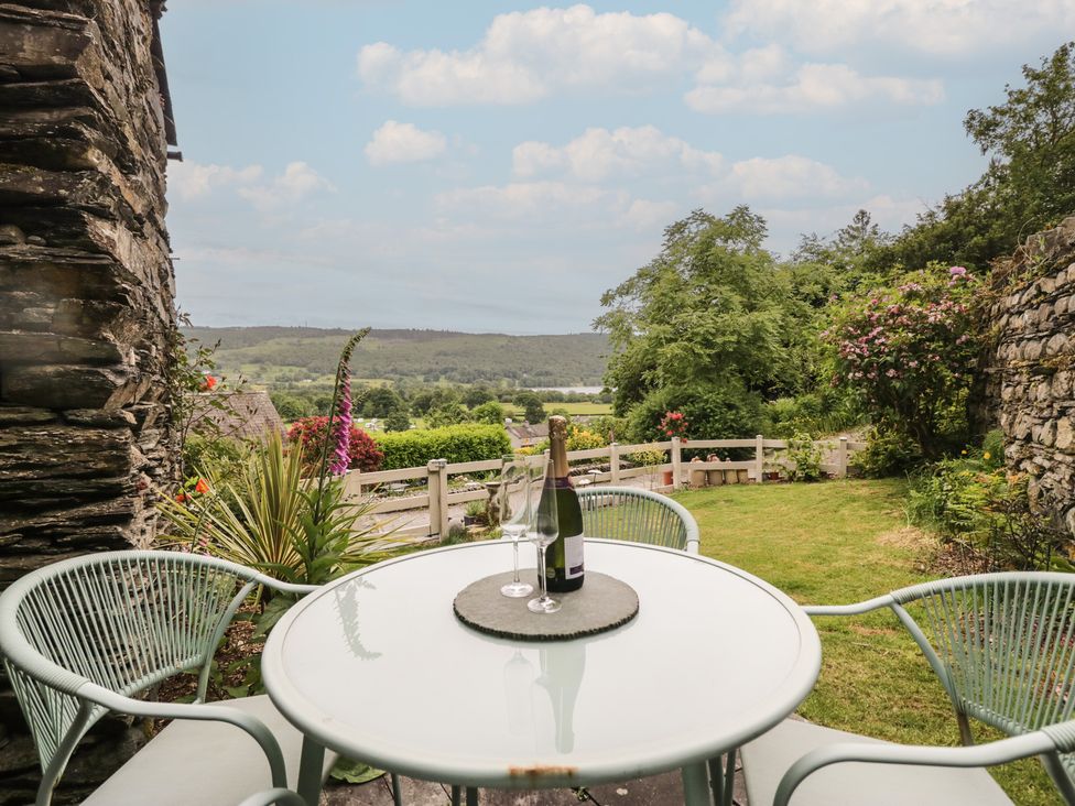 A table with champagne and glasses in a garden at Over Brow Cottage in Coniston