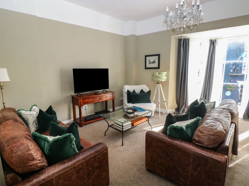 A living room with a sofa and coffee table at Sea Suite