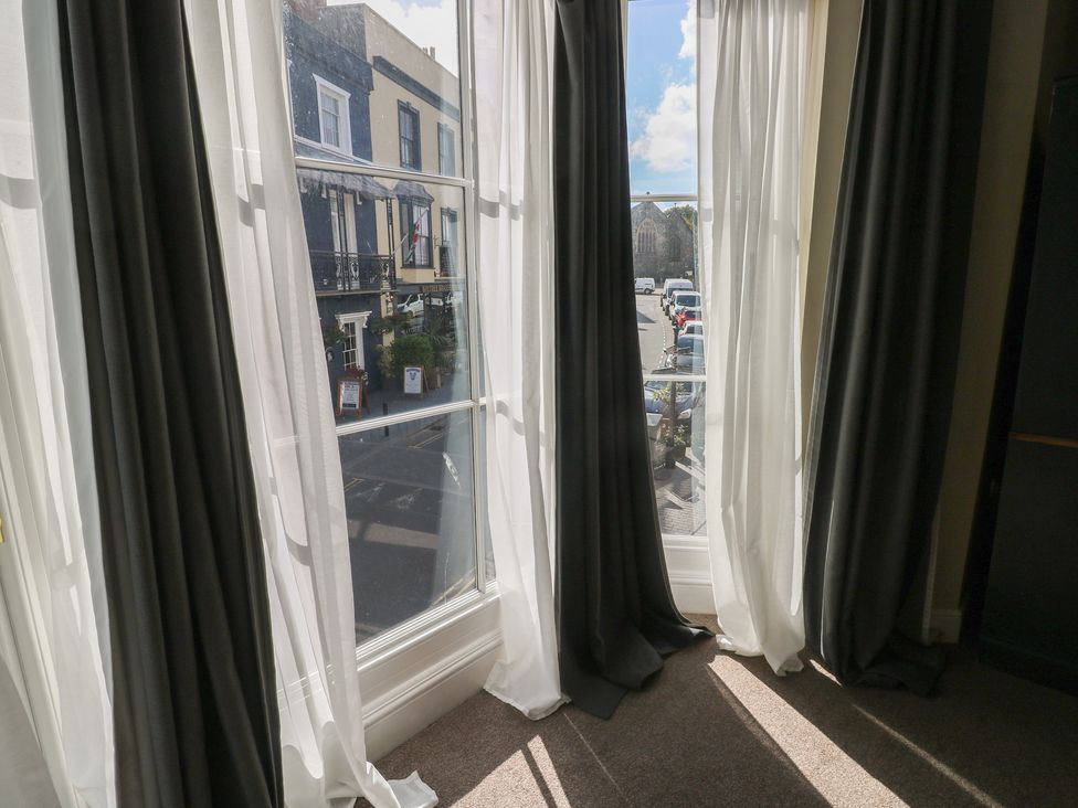 A window with curtains and a street view at Sea Suite in 
