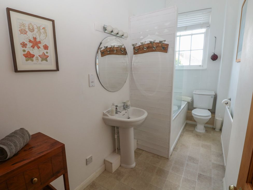 A bathroom with a sink and a shower at Sea Suite 