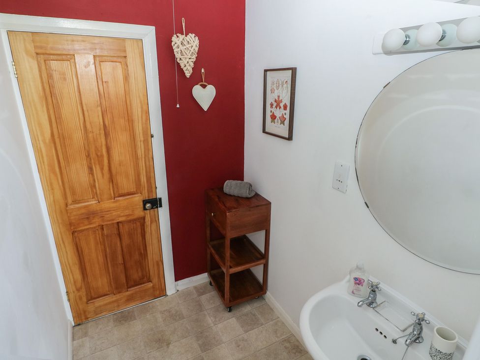 A bathroom with a sink and mirror at Sea Suite