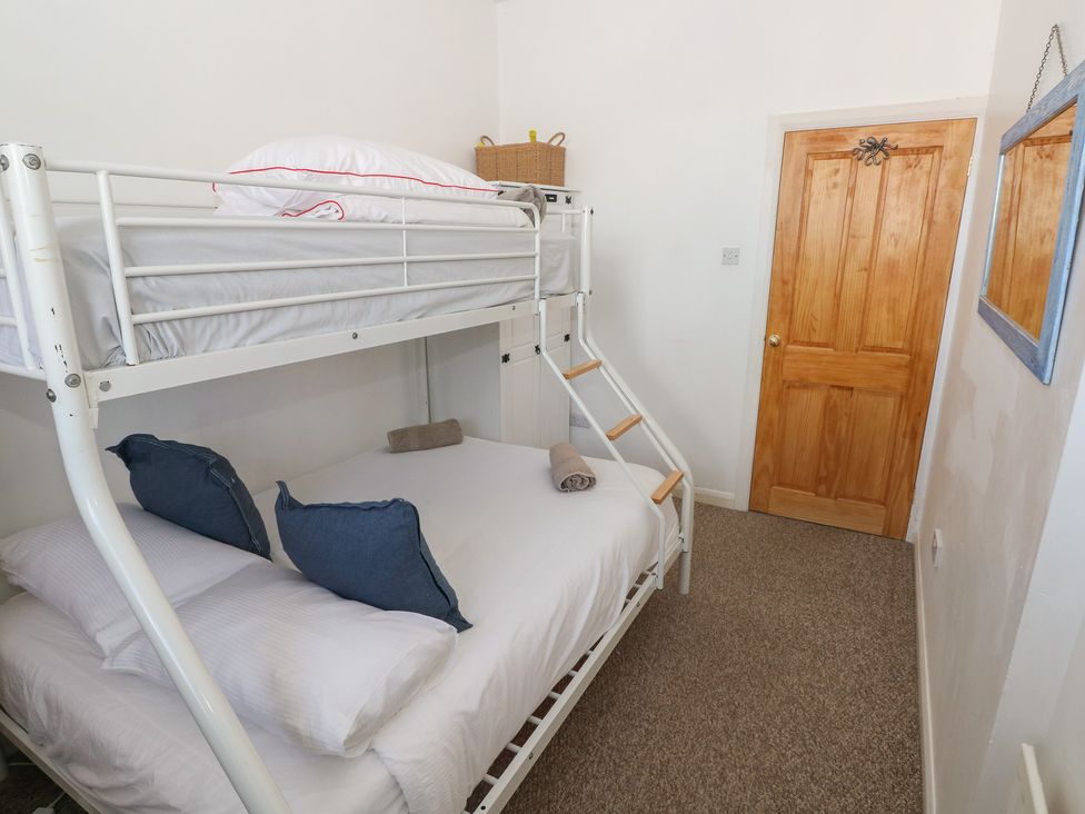 A bedroom with a bunk bed and a double bed at Sea Suite