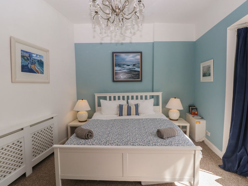 A bedroom with a bed and lamps at Sea Suite