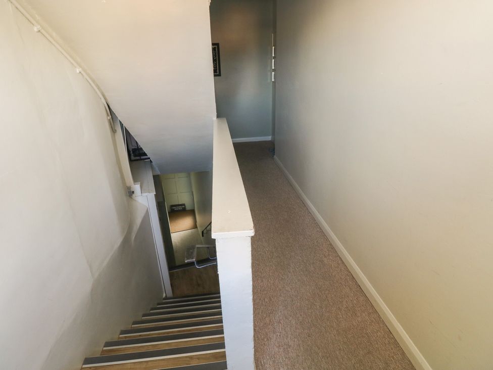 A hallway with stairs and a door at Sea Suite 