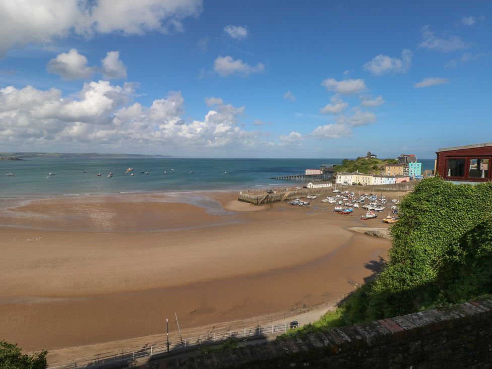 A beach view with boats and buildings at Sea Suite 