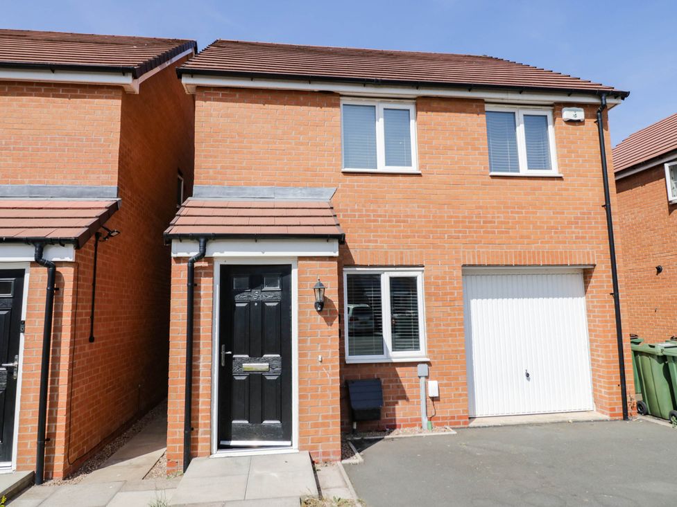 A house with a black door and garage at 5 Warrington Lane Coventry