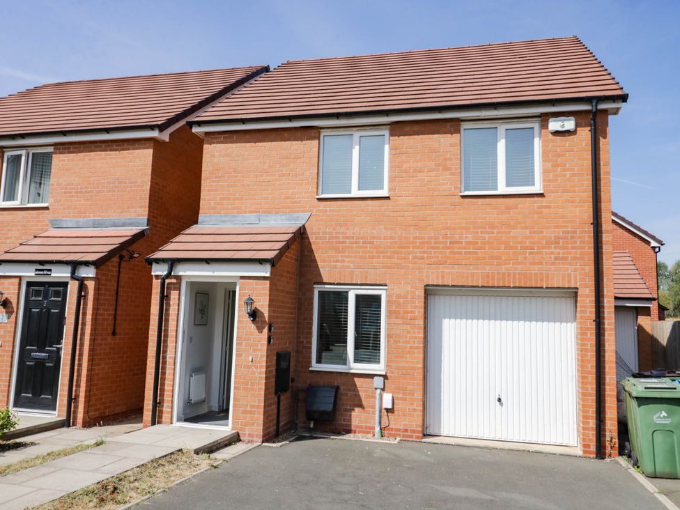 A house with a garage and front door at 5 Warrington Lane in Coventry