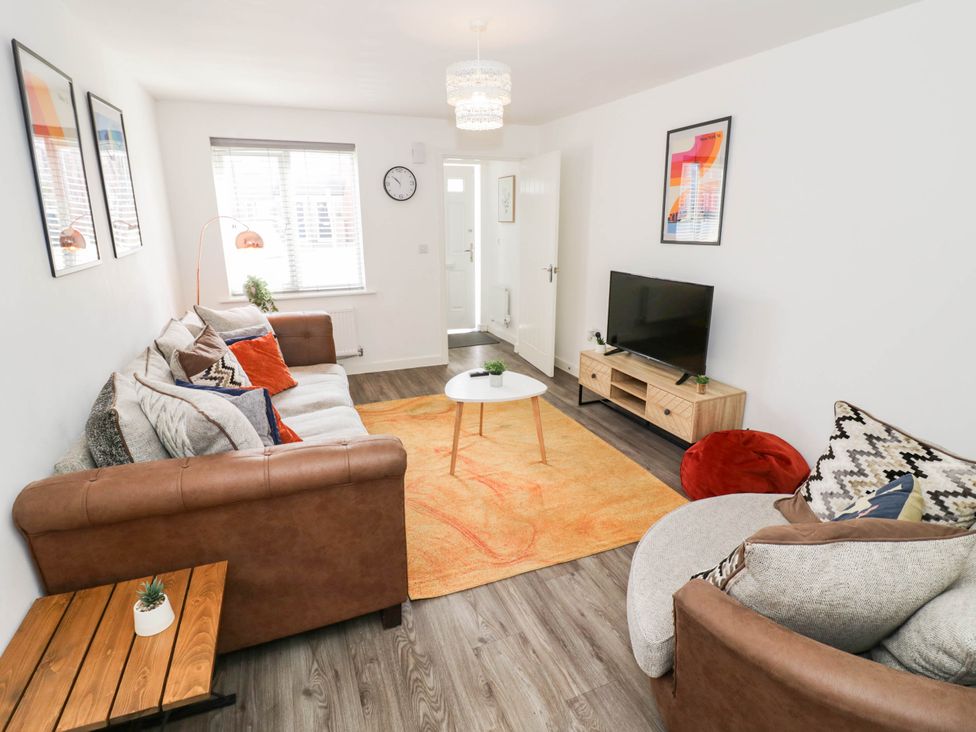 A living room with a sofa and coffee table at 5 Warrington Lane in Coventry