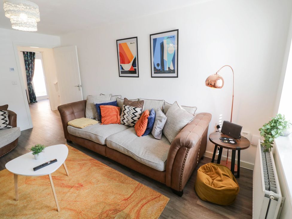 A living room with a sofa and coffee table at 5 Warrington Lane in Coventry