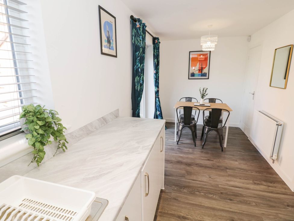 A dining room with a table and chairs at 5 Warrington Lane in Coventry