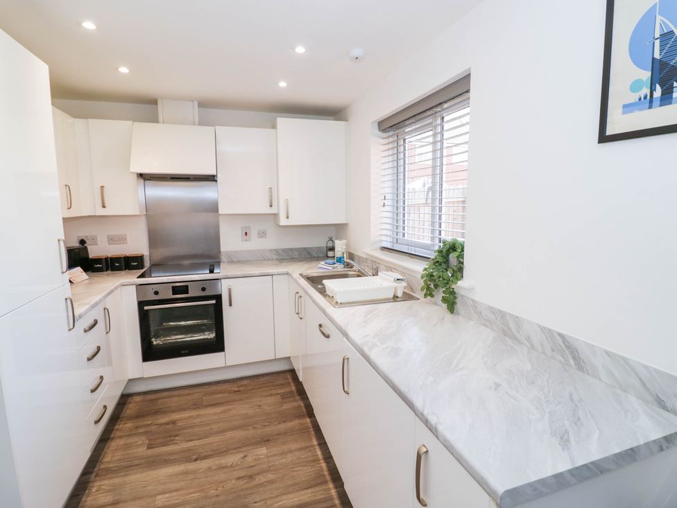 A kitchen with cabinets and oven at 5 Warrington Lane in Coventry