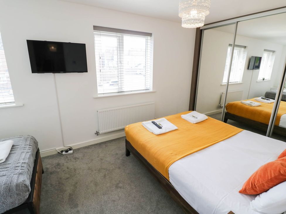 A bedroom with a bed and television at 5 Warrington Lane Coventry