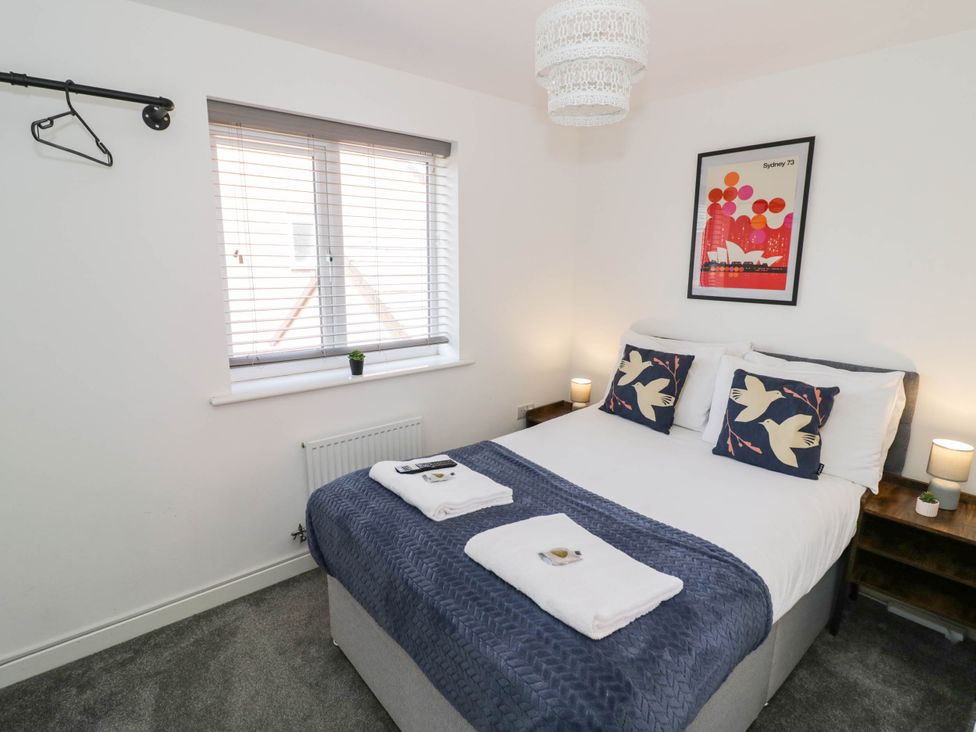 A bedroom with a bed and wall art at 5 Warrington Lane Coventry