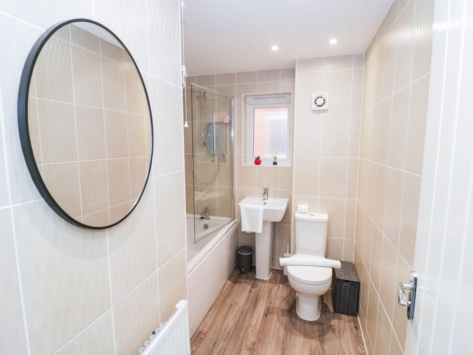 A bathroom with a bathtub, toilet, and sink at 5 Warrington Lane, Coventry