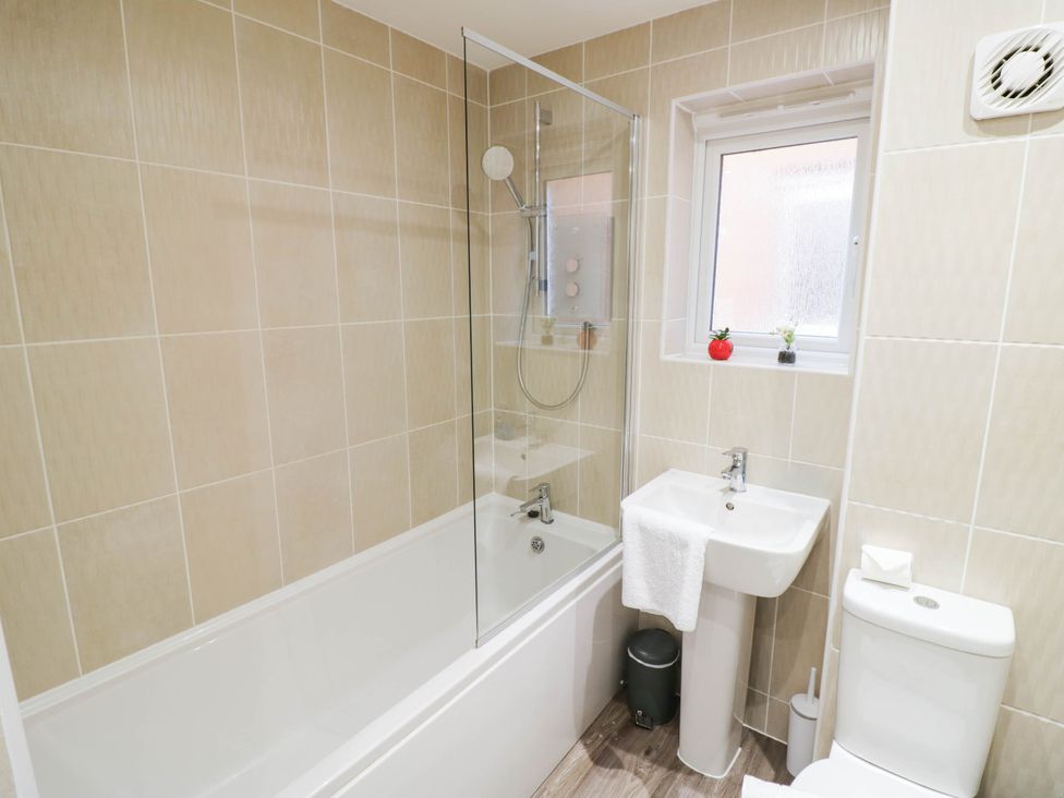 A bathroom with a bathtub and shower at 5 Warrington Lane Coventry